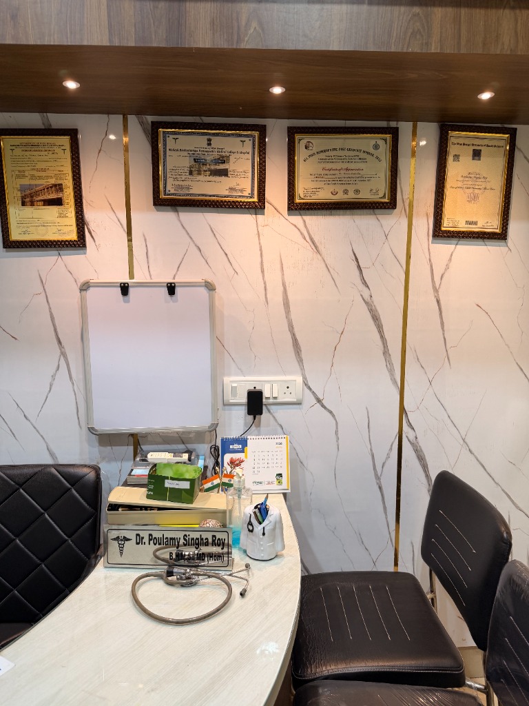Clinic consultation room setup with certificates