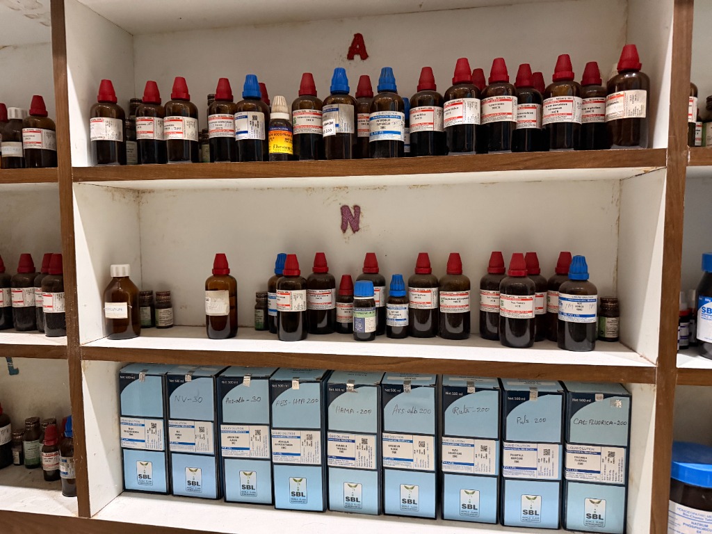 Clinic dispensary shelves filled with homeopathic dilutions
