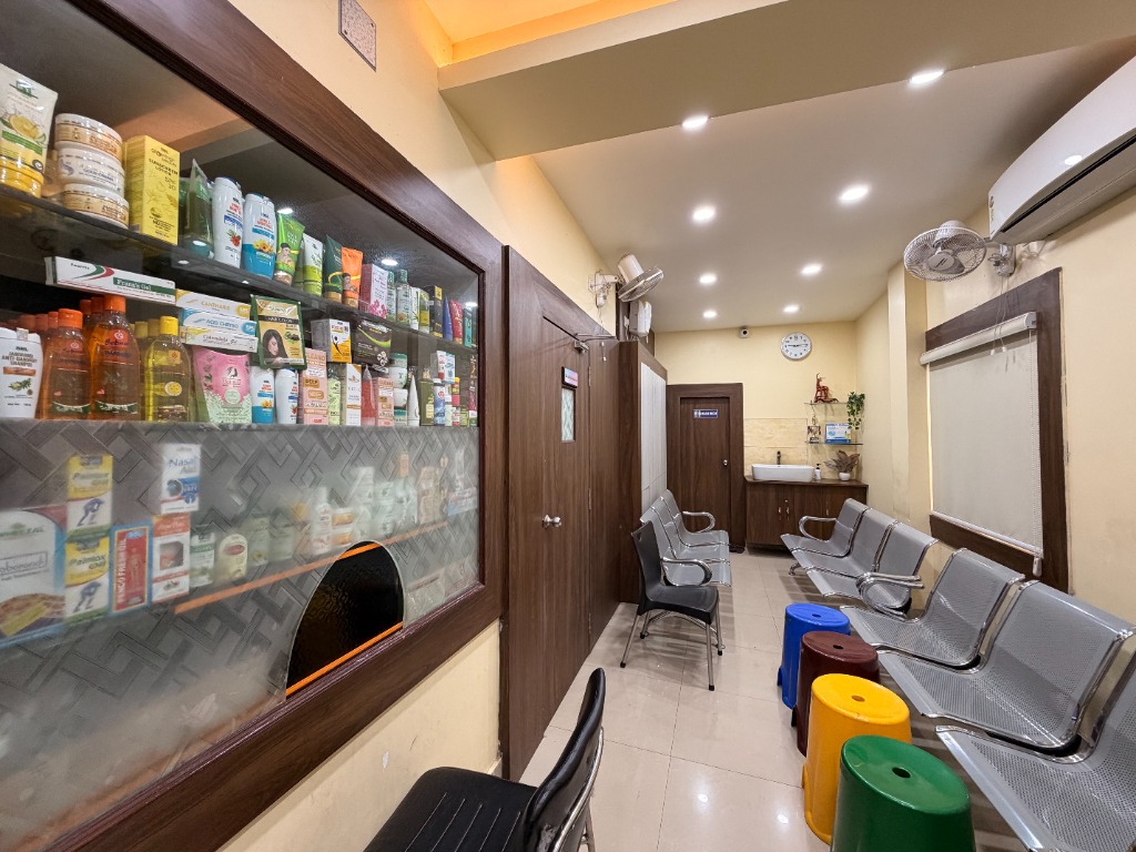 Clinic waiting area with chairs and floral desk